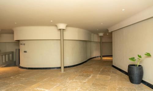 a room with a large wall with a plant in it at ORO The Estates, Nandi Hills in Nandigunda