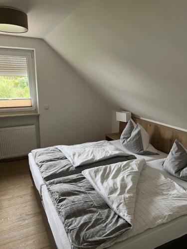 a large bed in a bedroom with a window at Zum Wispertal in Bad Schwalbach
