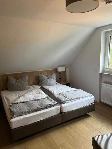 a large bed in a bedroom with a ceiling at Zum Wispertal in Bad Schwalbach