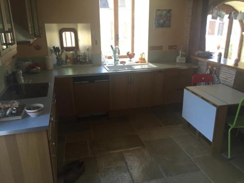 a kitchen with a sink and a counter top at La Maison du Pas Trop in Athie