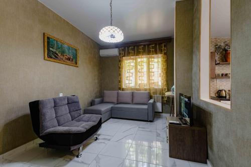 a living room with a couch and a chair at Urban Villa Tbilisi City in Tbilisi City