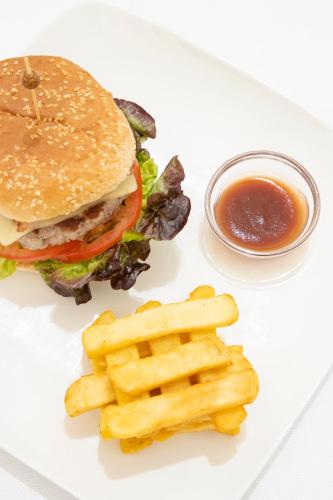 a plate with a hamburger and french fries and sauce at Canyamel Park Hotel & Spa - 4* Sup - Adults only (+16) in Canyamel