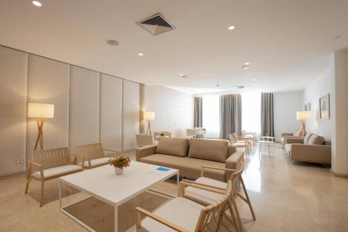 a living room with a couch and a table and chairs at Canyamel Park Hotel & Spa - 4* Sup - Adults only (+16) in Canyamel