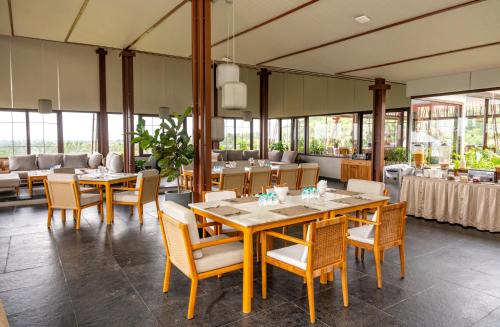 a dining room with a table and chairs and tables and chairsktop at ORO The Estates, Nandi Hills in Nandigunda