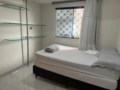 a bedroom with a large bed with a window at Casa a 3 km da praia de Ponta Negra in Natal