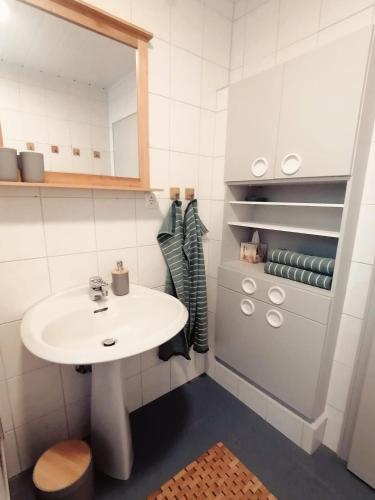 a white bathroom with a sink and a counter at Augl Bischofsgrün in Bischofsgrün