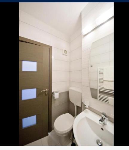 a bathroom with a toilet and a sink at Boulevard residence in Alba Iulia
