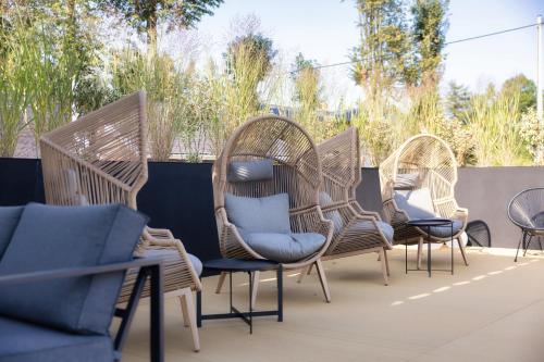 a group of wicker chairs sitting on a patio at Anaberg in Nowa Ruda