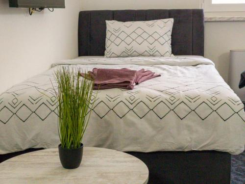 a bed with a black headboard and a table at Motel Anić in Novi Travnik
