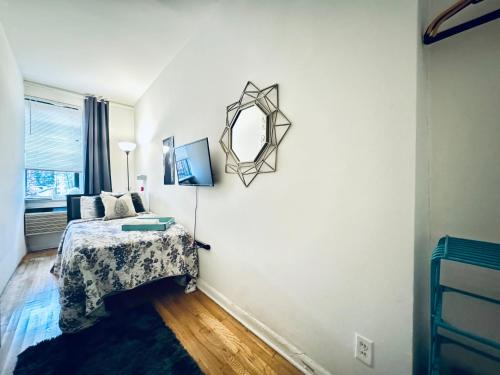 a bedroom with a bed and a mirror on the wall at UES Manhattan ROOM #2 in Shared Apartment in New York