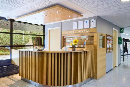 an office with a reception counter in a building at Hostel Linnasmäki in Turku