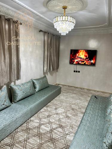 a living room with a couch and a fireplace at Appartements Meublés servitio 1 in Laayoune