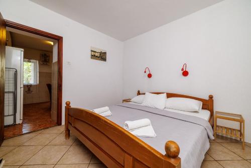 a bedroom with a bed with two towels on it at Apartment Klara in Senj