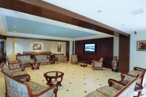 a lobby with couches and chairs and a table at Hotel Jaume I in Andorra la Vella