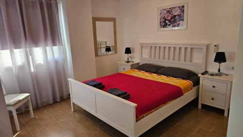 a bedroom with a large bed with a red blanket at Playa del Sol-Casa Playa in Denia