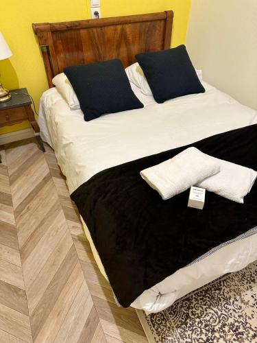 - un lit avec des draps et des oreillers en noir et blanc dans l'établissement L'élégant - Gare Centre - 2 Pers, au Mans