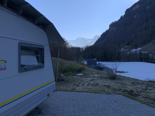a close up of the back of a camper parked next to a lake at Revier caravan-ig und cool in Hätzingen