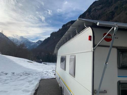 a camper is parked on a snow covered road at Revier caravan-ig und cool in Hätzingen