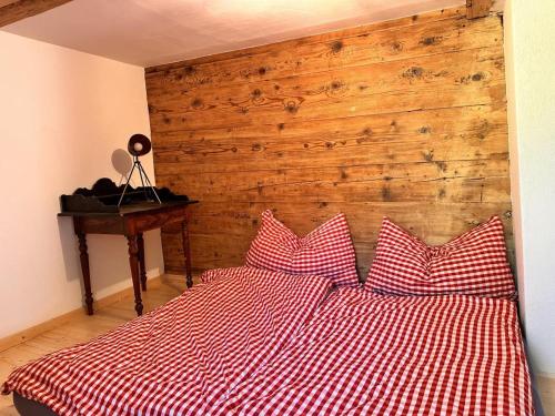 a bedroom with a red and white bed with two pillows at Revier Natur pur in Glarus