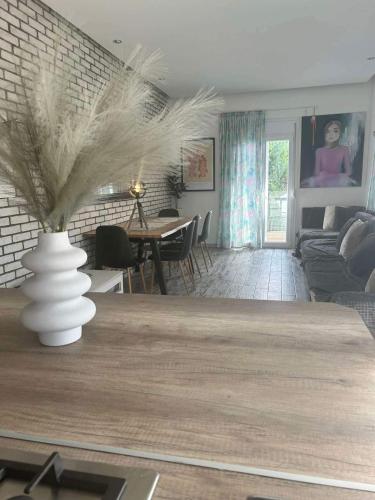 a living room with a vase on a table at Flat in Makrygialos in Makrýgialos