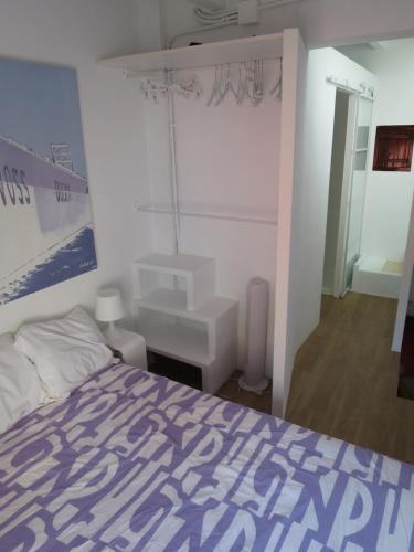 a bedroom with a bed and a sink at Casa al Castillo - charming & authentic townhouse - terrace with stunning castle views in Cullera