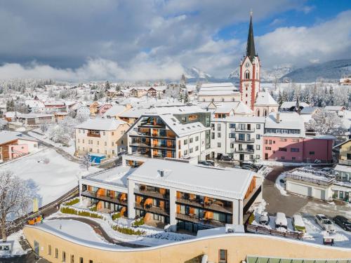 an aerial view of a city with snow covered buildings at AlpenParks Hotel & Apartment Carpe Solem Mariapfarr in Mariapfarr
