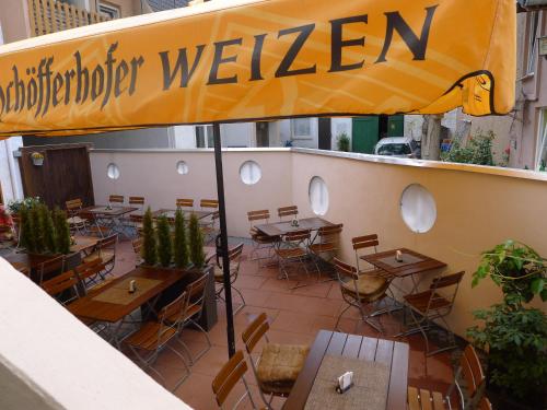 a restaurant with tables and chairs on a patio at Hotel Karthäuser Hof in Flörsheim