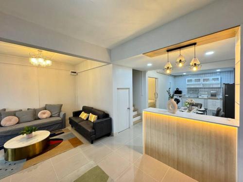 a living room with a couch and a table at MIQ HK256 5BR MRT Ratchada and HuaiKhwang in Bangkok