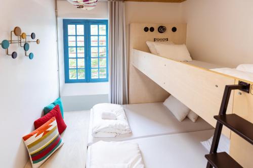 a room with a bunk bed and a staircase at JO&JOE Hossegor in Hossegor