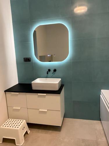 a bathroom with a sink and a mirror at Casa Axente in Baia-Sprie