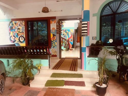 a house with plants in front of the front door at Happy Home Varkala in Varkala