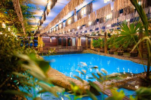 a large swimming pool in a building with plants at Cossara luxury villas - Adults Only in Balchik
