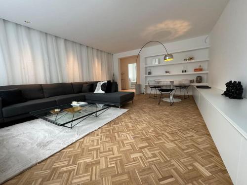 a living room with a couch and a table at Appartement neuf en plein centre in Namur