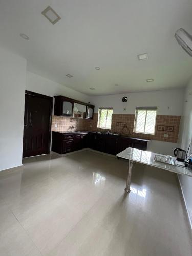 an empty room with a table in the middle at River View Resort by Periyar Ayurveda in Kodanad