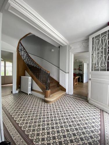a hallway with a spiral staircase in a house at Hôtel particulier Au pied de la cathédrale in Beauvais