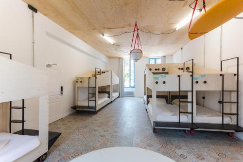 a room with several bunk beds in it at JO&JOE Hossegor in Hossegor
