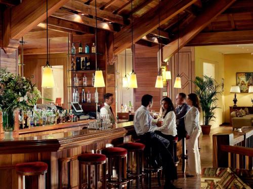 a group of people sitting at a bar at InterContinental Mzaar Lebanon Mountain Resort & Spa by IHG in Kfardebian