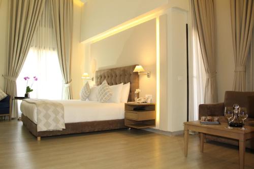 a bedroom with a large bed with a large mirror at InterContinental Mzaar Lebanon Mountain Resort & Spa by IHG in Kfardebian