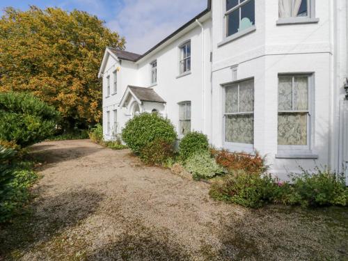 a white house with a yard in front of it at Rough Hill House in Chelmsford