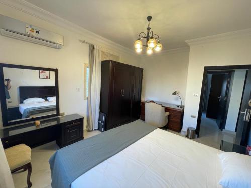 a bedroom with a large bed and a large mirror at Seaview luxury Villa in Ras El Hekhma - North Coast in Ras Elhekma