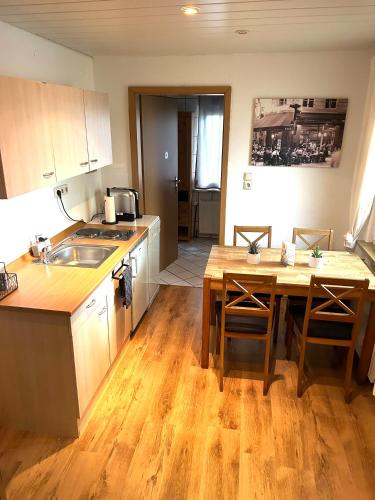 a kitchen with a table and a sink and a dining room at By Bamberg in Stegaurach