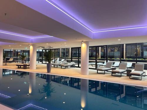 a hotel with a pool in the middle of a building at Modern Homy 1B1B APT Pool Gym Cinema Westfield Cafe in Phillip