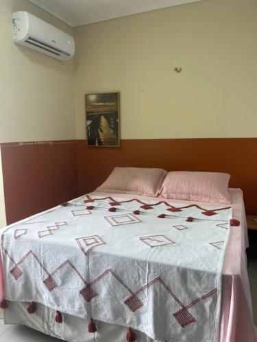 a bed with a quilt on it in a room at Flat Ilha Bela 22525 in Alter do Chao