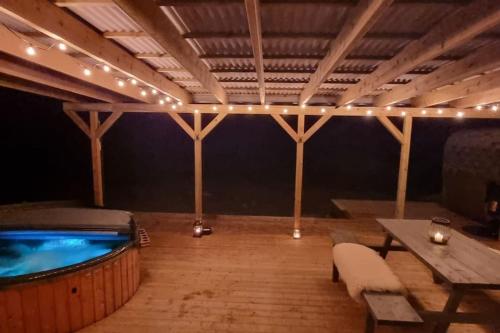 a room with a pool and a table and lights at Skoglund privat Villa in Trysil