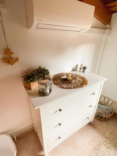 a white dresser with a bowl on top of it at Finca La Tortuga mit Pool und Klima in Algaida