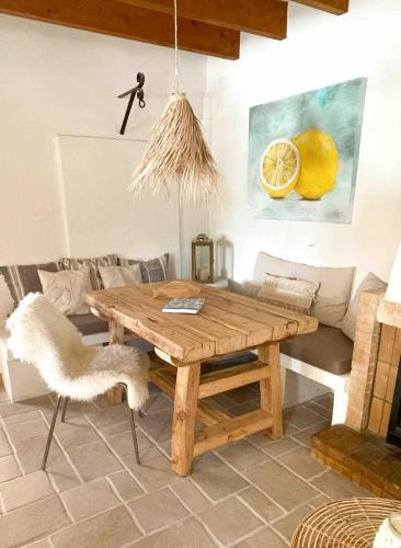 a wooden table and chair in a living room at Finca La Tortuga mit Pool und Klima in Algaida
