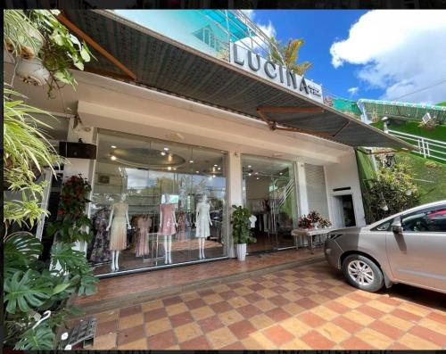 a clothing store with a car parked in front of it at Da Lat LUCINA Boutique Hotel in Da Lat