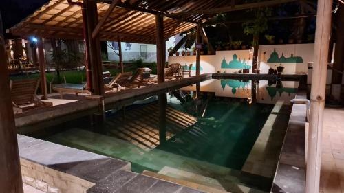 a pool at a resort at night at Alamanda Family Villas, Pool & Local Tours in Yogyakarta