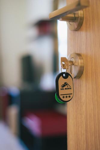 a lock on a door with a tag on it at Del Monte Predeal in Predeal