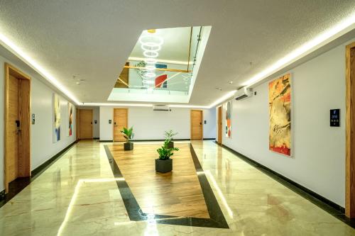 an empty hallway with potted plants in a building at ESPERO INN Malappuram in Malappuram